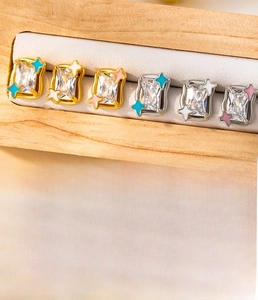 Detailed view of rectangular zircon earrings with star enamel in gold and silver plating