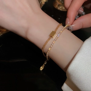 Detailed shot of a luxury double-layer gold bracelet featuring cubic zirconia crystals