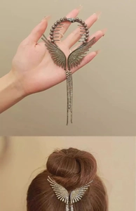 Detail view of rhinestone wing hair claw with long dangling tassels for hair bun styles