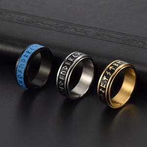 Viking rune spinning rings in gold, silver, and black finishes on leather background