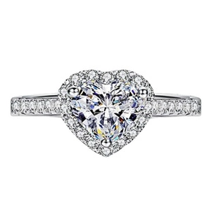 Macro detail of heart-shaped zircon ring with halo setting and pavé diamond band
