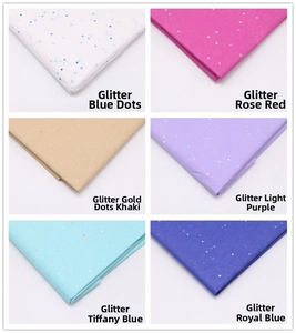 Nahaufnahme von glitzerndem Geschenkpapier in Farben wie Königsblau und Rosarot