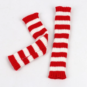 Detailed close-up of knitted red and white striped arm warmers on white background