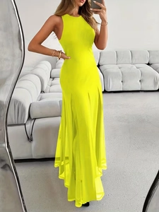 Detailed view of the flowing pleated hem on a neon yellow sleeveless maxi dress