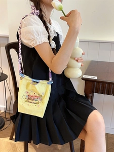 Yellow embroidery crossbody bag with carousel pattern and colorful woven strap
