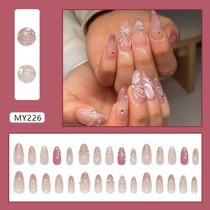 Pink cat-eye press-on nails with white butterfly, pearls and almond shape gradient