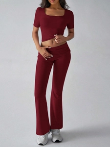 Deep red Y2K two-piece set featuring short sleeve crop top and high-waisted flared trousers