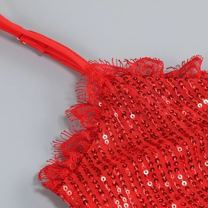 Detail of red sequins, delicate lace trim and adjustable strap on the heart-cutout dress
