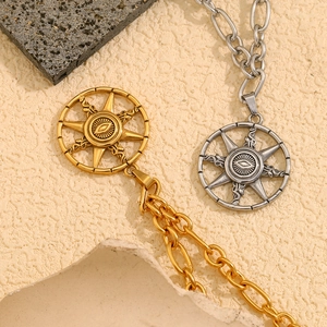 Detail of 18K gold and silver starburst evil eye necklaces with sun pendants