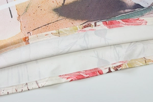 Detail of floral printed hem with neat overlock stitching on polyester long dress