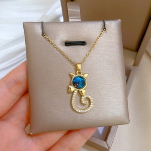Golden cat pendant necklace with starry blue bead and sparkling white zircon pavé