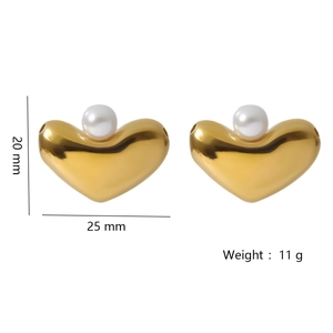 Golden heart-shaped earrings with white pearl detail, measuring 25mm wide and 20mm high