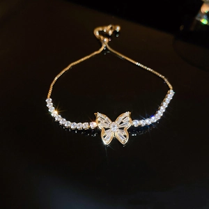 Detail of adjustable gold butterfly bracelet featuring sparkling zircon butterfly pendant
