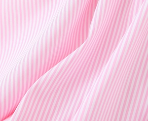 Detailed close-up of soft pink and white vertical striped cotton fabric texture