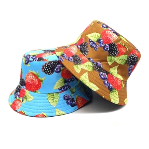Reversible bucket hat with fruit print featuring strawberries and blueberries in blue and brown