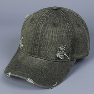 Close-up of distressed army green washed denim baseball cap with vintage frayed holes