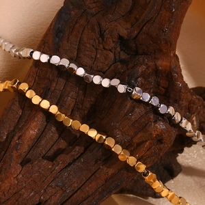 Minimalist square bead chain necklace in gold and silver finish on rustic wood