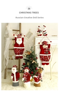 Detailed view of plush Santa, Snowman, and Reindeer Christmas dolls for home decoration