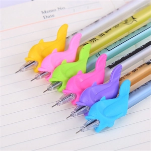 Detail of multi-color dolphin-shaped silicone pencil grips on lined notebook paper