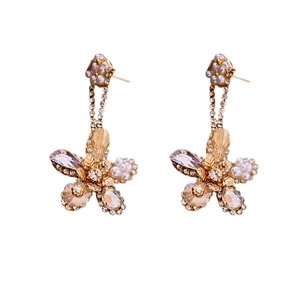 Elegant gold-tone flower drop earrings with zircon crystals and faux pearls on white base