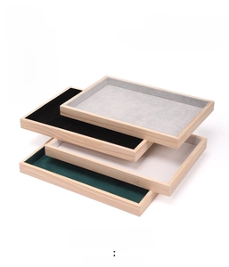 Macro detail of stackable solid wood jewelry trays with velvet lining in four colors
