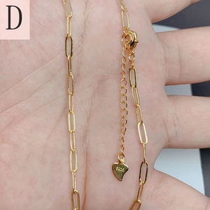 Macro shot of gold-plated paperclip chain necklace with S925 engraved heart pendant