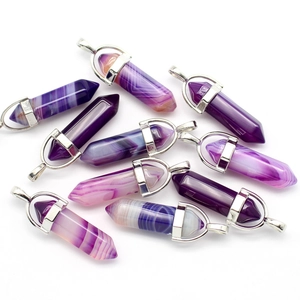 Detailed view of ten purple hexagonal crystal pendants with silver metal clasps on white
