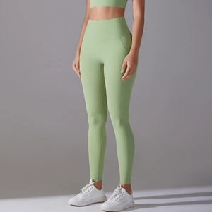 Detail of high-waisted mint green yoga leggings with seamless athletic stretch fabric
