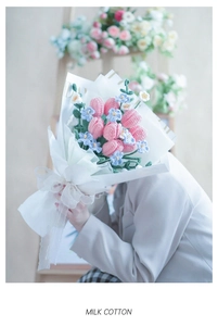 Close-up of handmade milk cotton crochet flowers with elegant floral tissue wrapping