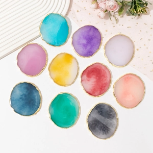 Flat lay of resin agate nail art palettes in various colors with elegant gold edges