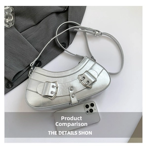 Top view of silver metallic crescent bag with Y2K buckle details and phone for size