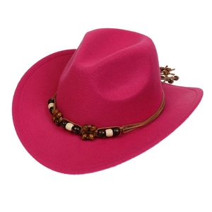 Detail of rose red wool western cowboy hat with a beaded woven decorative band