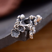 Macro shot of S925 sterling silver plum blossom spacer bead with a vintage finish