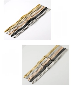 Detail view of multicolored stainless steel watch-style bracelets in gold and black finish