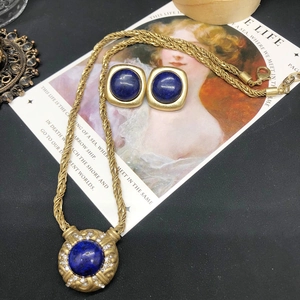 Vintage gold necklace with lapis lazuli pendant and matching square earrings on art card