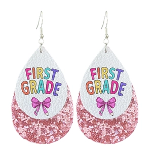 Detail of tear-drop leather earrings with 'First Grade' print and pink glitter layer