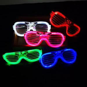 Five LED shutter glasses in white red pink green and blue glowing in dark setting