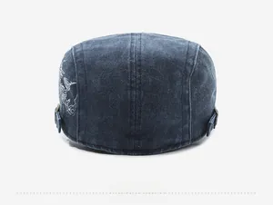 Detail view of the back of washed denim ivy cap with embroidery and adjustable metal buckle