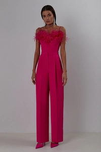 Detail of rose red jumpsuit featuring premium ostrich feather trim and slim fit silhouette
