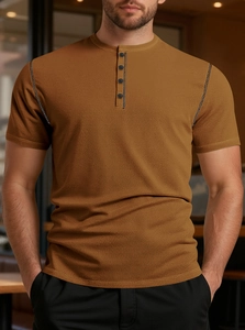 Detail of caramel waffle knit fabric and contrast stitching on a men's Henley shirt