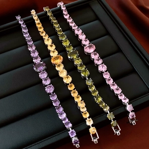 Detailed macro of crystal tennis bracelets in purple, amber, green, and pink colors