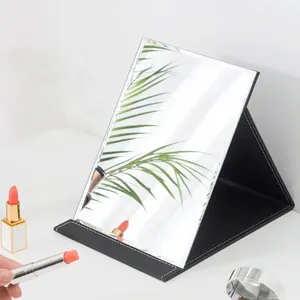 Portable folding makeup mirror with black leather stand and white stitching details