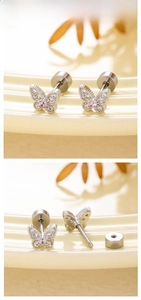 Detail of silver butterfly ear studs with pink zircon and screw-back closure system
