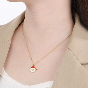 Close-up of a model wearing a gold stainless steel necklace with Santa Claus pendant