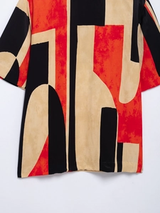 Detail of abstract red and beige print on professional flat lay women's shirt