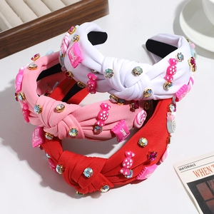 Knotted fabric headbands with candy charms and rhinestones in red, pink, and white