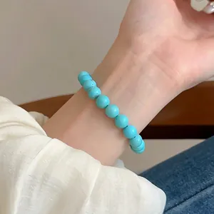 Sky blue turquoise beaded elastic bracelet with natural texture on a wrist