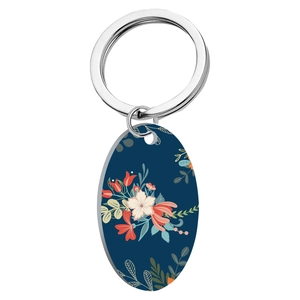 Stainless steel keychain with oval vintage blue floral pendant on a white background