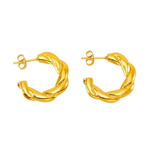 Macro view of gold-colored twisted hoop earrings with textured spiral design on white background