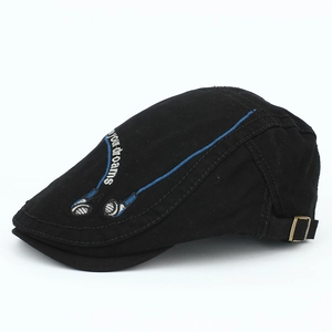 Detail of black cotton beret featuring blue headphone embroidery and metal buckle